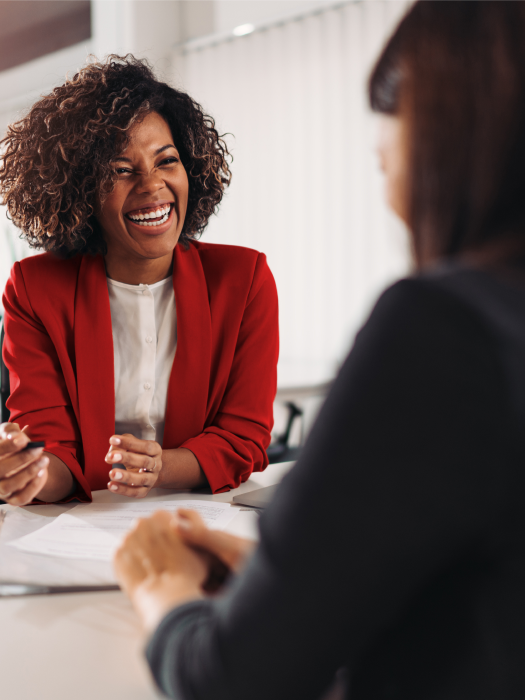 Black finanical advsior smiling in conversation with client